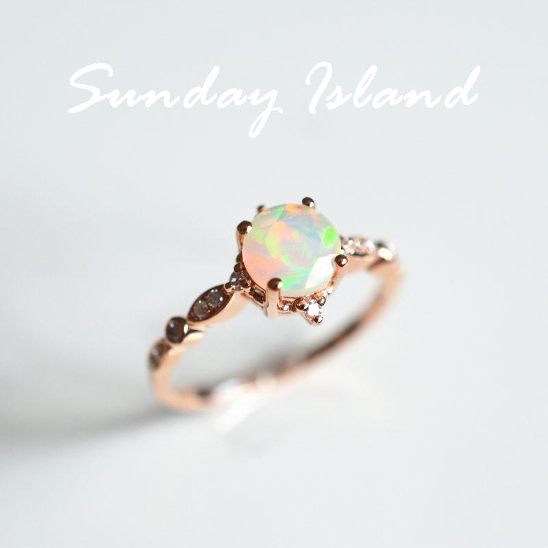 a colorful opal stone set in a rose gold twisted band